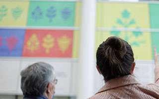 The Ottawa Hospital’s land acknowledgement sign with artists Simon Brascoupé (left) and Mairi Brascoupé (right) in the foreground